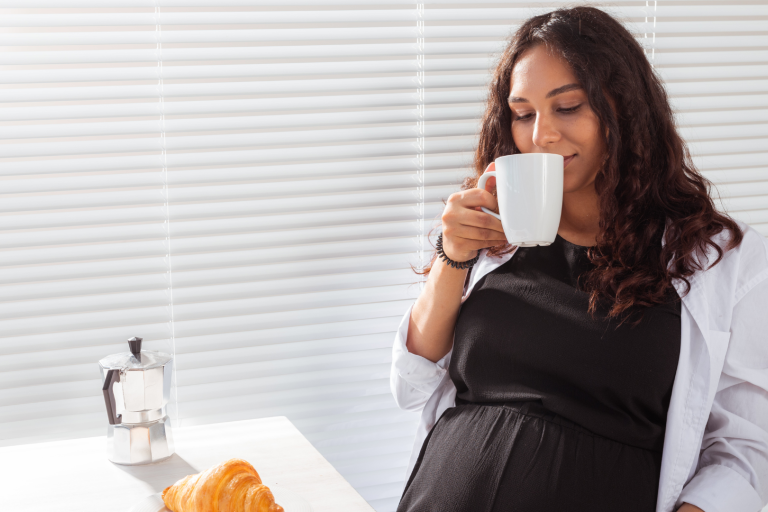 Pregnant lady drink a cup of coffee