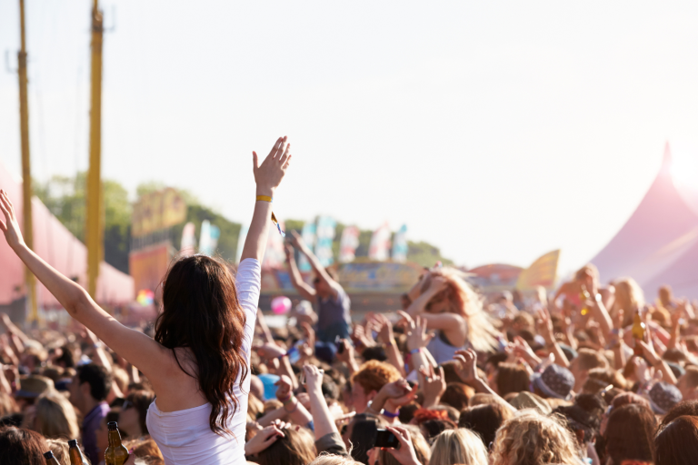 crowd at festival with female waving arms