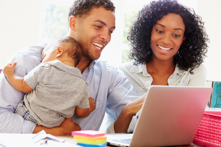 Family with baby looking at a computer