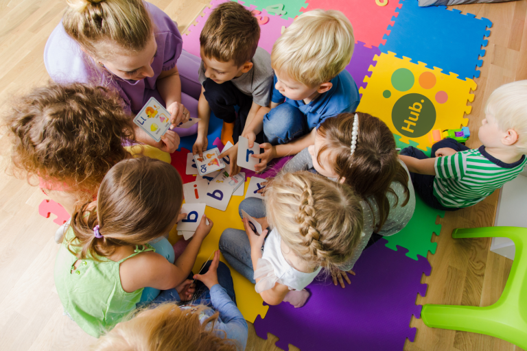 group toddlers sitting on floor doing an activity