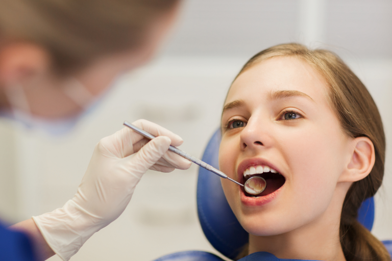 Teenage girl getting dental treatment