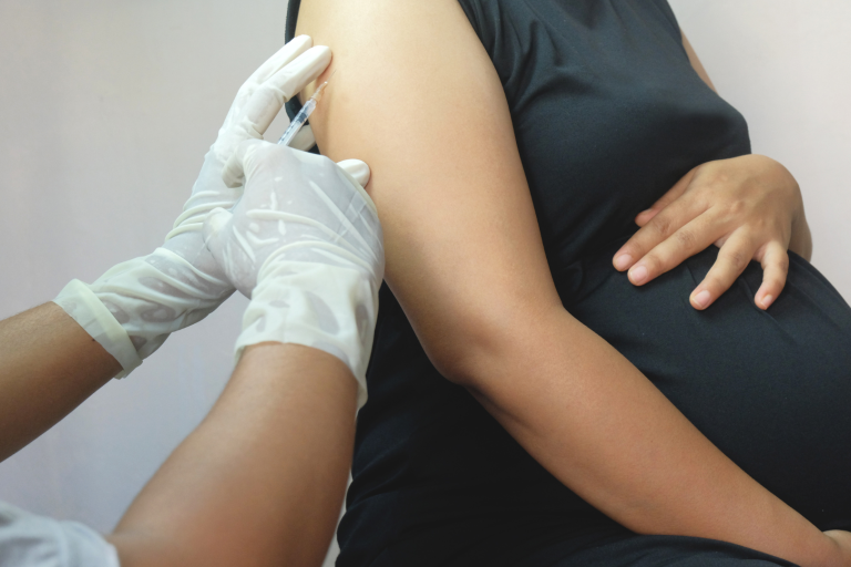 Nurse vaccinating Pregnant lady 